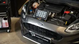 Diagnostic tablet connected to a Ford Fiesta engine during a Stage 1 remap in the workshop.